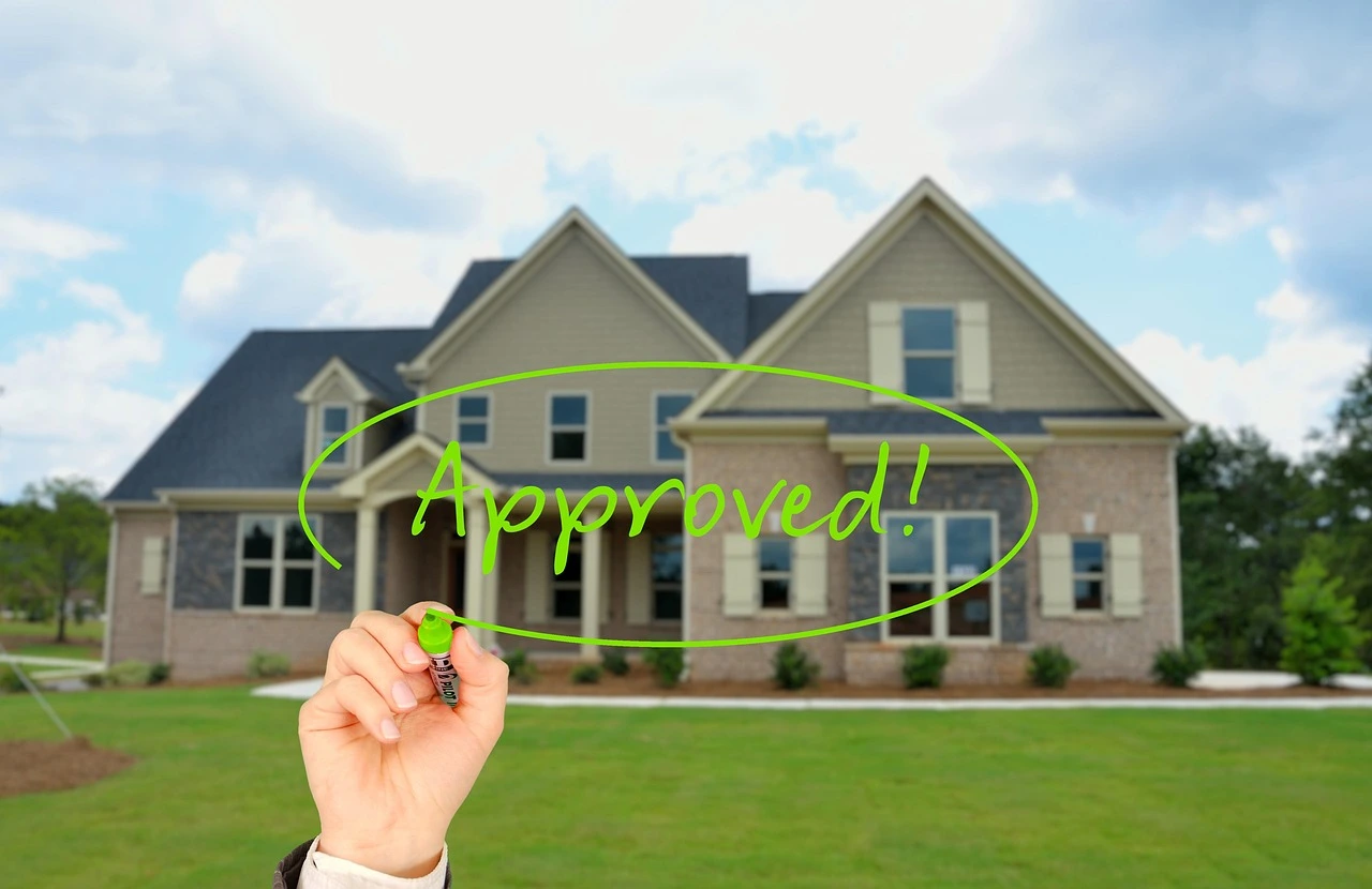 A real estate agent shaking hands with a happy homebuyer at closing